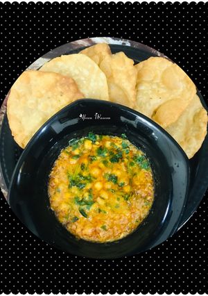 A picture of Dhaba style chana masala with puri.