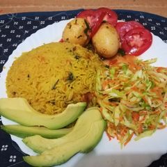 A picture of Tumeric rice with sausages, egg curry and salad.