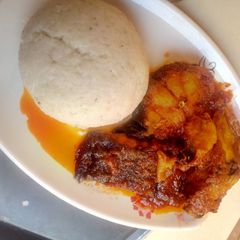 A picture of Tuwon Rice and Tomato soup with Tilapia fish.