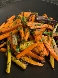 A picture of Roasted Carrots with Thyme, Oregano, and Parsley.