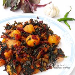 A picture of Sauteed baby potatoes with beetroot and amaranth leaves.