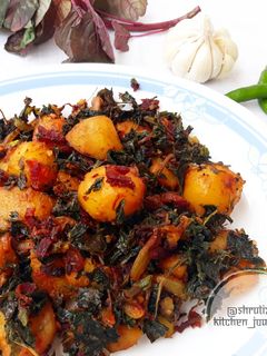 A picture of Sauteed baby potatoes with beetroot and amaranth leaves.