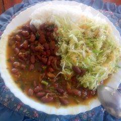 A picture of Boiled rice and fried red beans with steamed cabbages.