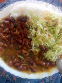A picture of Boiled rice and fried red beans with steamed cabbages.