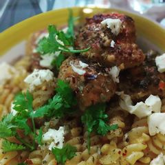 A picture of Mutton meat balls and fusilli pasta in tomato emulsion.