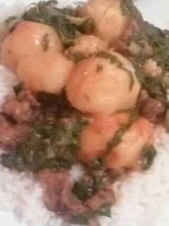 A picture of Rice with a spinach and beef stew.
