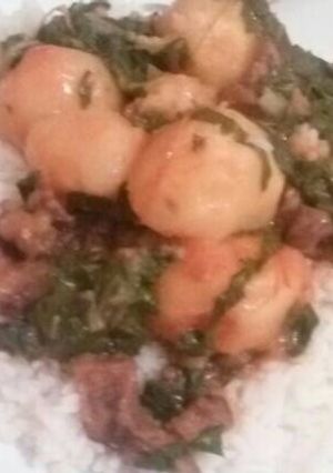A picture of Rice with a spinach and beef stew.