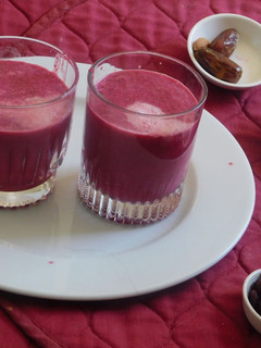 A picture of Cold beet almond milkshake with dried cranberries and dates.