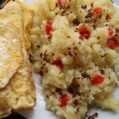 A picture of Mashed potatoes with fried eggs.