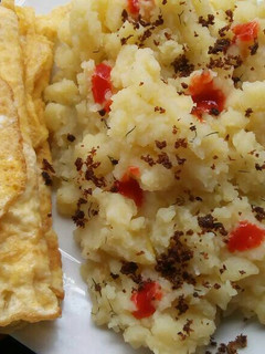 A picture of Mashed potatoes with fried eggs.