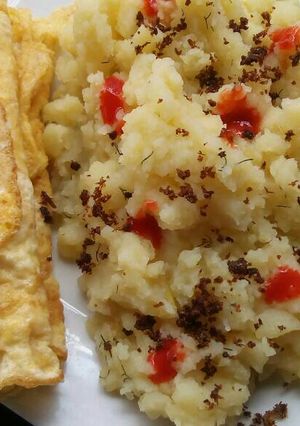 A picture of Mashed potatoes with fried eggs.
