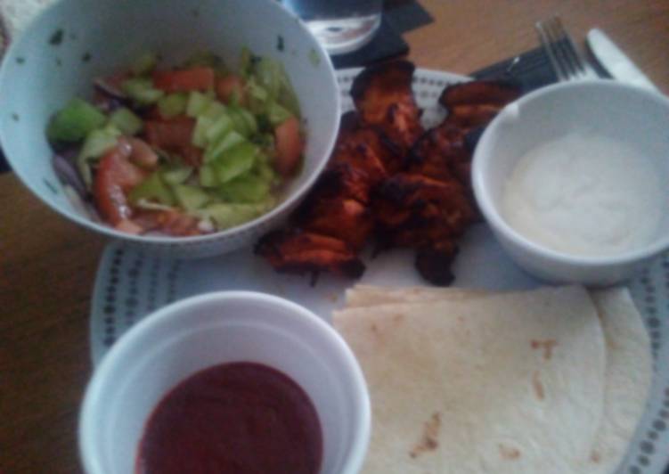Grilled Chicken Kebabs, salad and wraps with dips