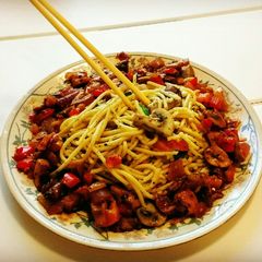 A picture of Italian Spaghetti with pan fried mushrooms.