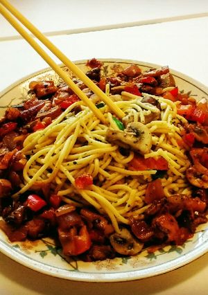 A picture of Italian Spaghetti with pan fried mushrooms.