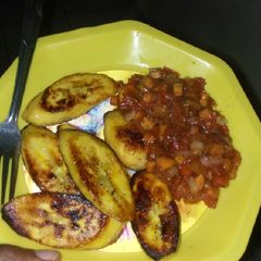 A picture of Pan-seared ripe plantains with tomato and carrot sauce.