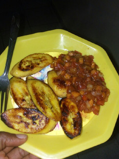 A picture of Pan-seared ripe plantains with tomato and carrot sauce.