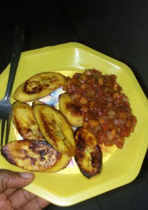 A picture of Pan-seared ripe plantains with tomato and carrot sauce.
