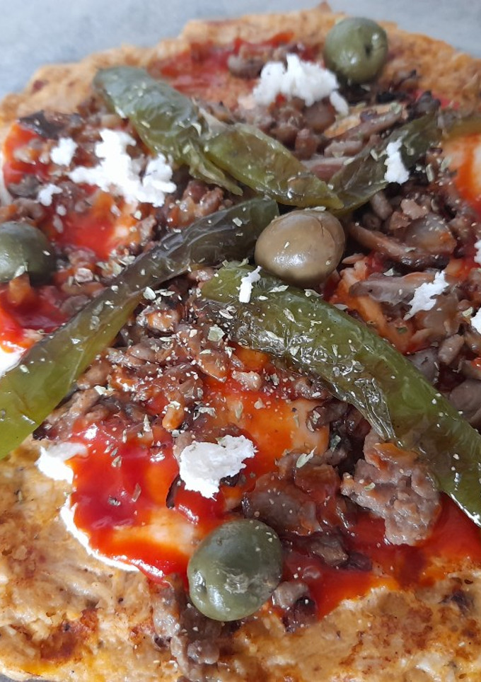 Una foto de Pizza con masa base de pollo