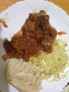 A picture of Ugali wa Mala served with fried beef and cabbage.