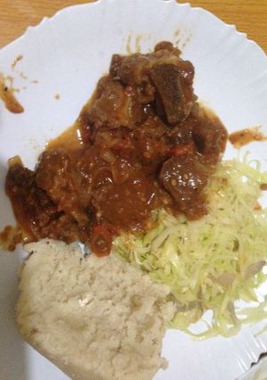 A picture of Ugali wa Mala served with fried beef and cabbage.