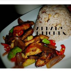 A picture of Rice and beans with chicken sauce.