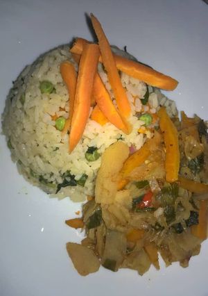 A picture of White fried rice with potato and vegetable soup.