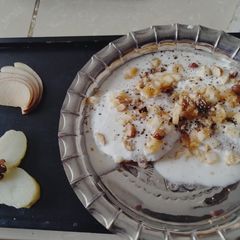 A picture of Dry fruit stuffed aloo tikki chaat in sweet curd & apple.