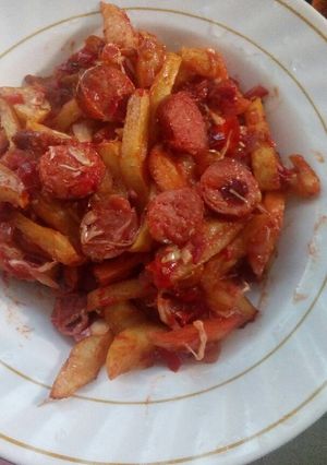 A picture of Chips masala and fried sausages.