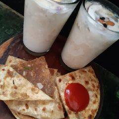 A picture of Coconut dry fruit shake with sattu paratha.