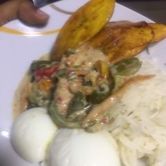 A picture of Fried plantain, boiled egg with chicken creamy sauce.