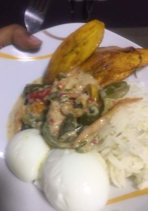 A picture of Fried plantain, boiled egg with chicken creamy sauce.