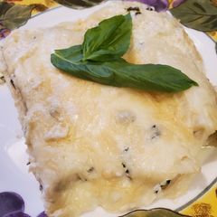 A picture of Brad's crab florentine manicotti w/ parmesan, basil, caper sauce.