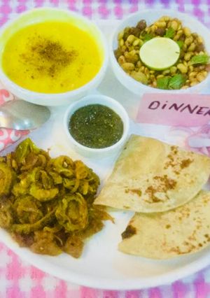 A picture of Yellow Moong Dal,Karela,Onions Bhaji,Whole lentils salad,mint chutney,Chapatis.