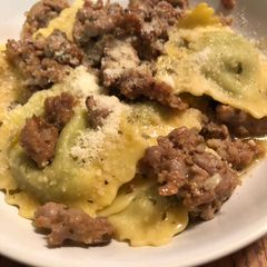 A picture of Easy Ravioli in a sausage, garlic, and wine sauce.
