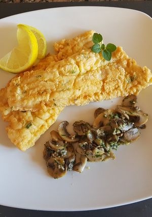 Una foto de Filet de merluza, con guarnición de hongos a la provenzal