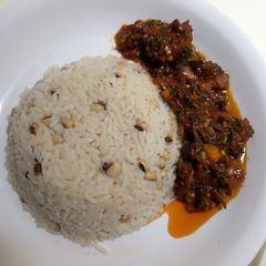 A picture of Rice and beans with stew.