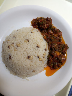 A picture of Rice and beans with stew.
