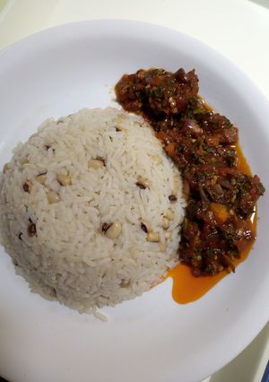 A picture of Rice and beans with stew.