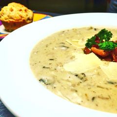 A picture of Cream of Mushroom Soup with Parmesan Cheese and Applewood Smoked Bacon.