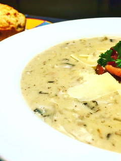 A picture of Cream of Mushroom Soup with Parmesan Cheese and Applewood Smoked Bacon.