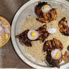 A picture of Grilled chicken with Mandi rice.