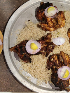 A picture of Grilled chicken with Mandi rice.