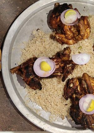 A picture of Grilled chicken with Mandi rice.