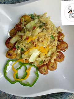 A picture of Fried plantain with steamed cabbage and egg.