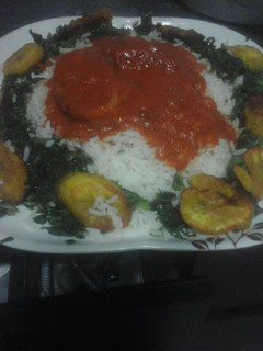 A picture of White rice and stew with steamed spinach.