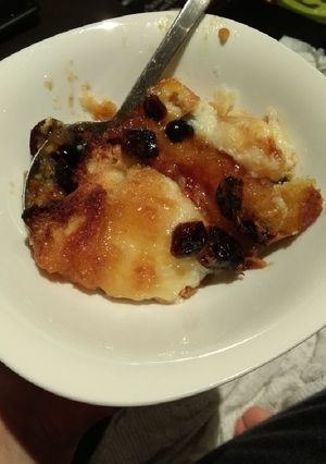 A picture of Bread and butter pudding with jam and cranberries.