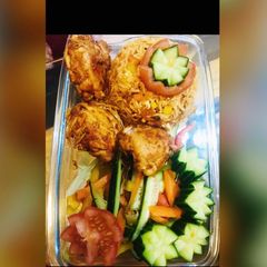 A picture of Chicken tikka with veg fried rice.