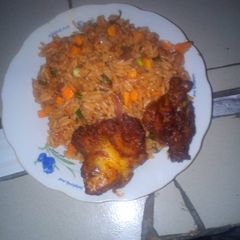 A picture of Garnish jollof and pepper chicken.