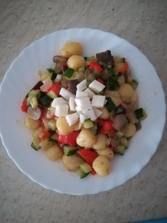 Una foto de Ñoquis con queso, setas y verduras