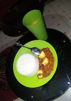 A picture of Egg curry and rice.
